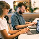 two independent contractors working on laptops