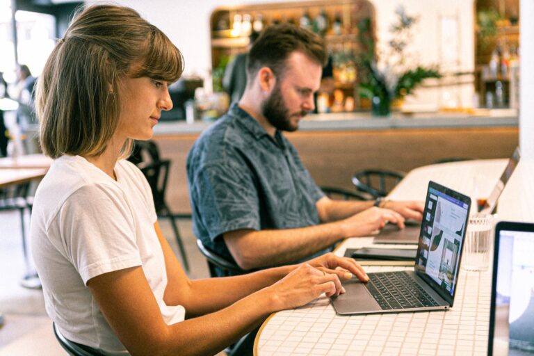 two independent contractors working on laptops